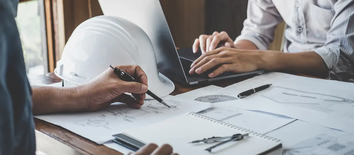 A New Horizons engineer reviewing drawings with a client team